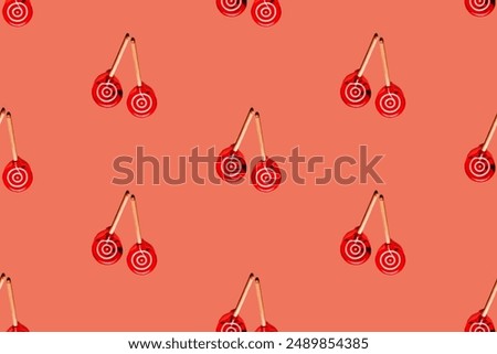 cherry-liked seamless pattern of delirious lollipops twins on an orange backdrop