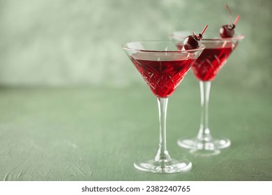 Cherrytini. Red alcoholic cherry martini cocktail with cherry garnish in martini glasses - Powered by Shutterstock