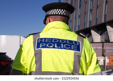 Cheshire, United Kingdom - 2nd Oct 2019: Welsh Police Officer Standing Guard On The Street.