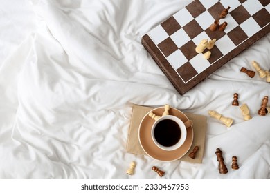 Chess board with cup of coffee on bed, top view - Powered by Shutterstock