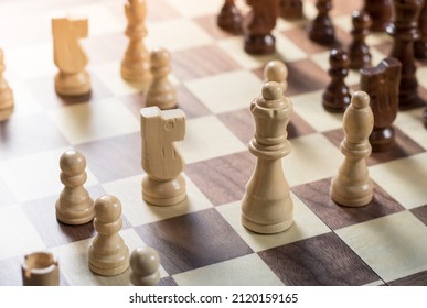 Chess Board With Chess Game Being Played. Top Down Angle. White's Queen And Knight In Focus