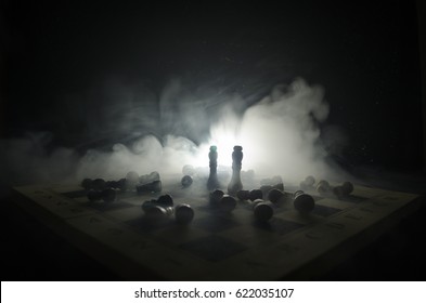 chess board game concept of business ideas and competition and strategy ideas concep. Chess figures on a dark background with smoke and fog. Selective focus