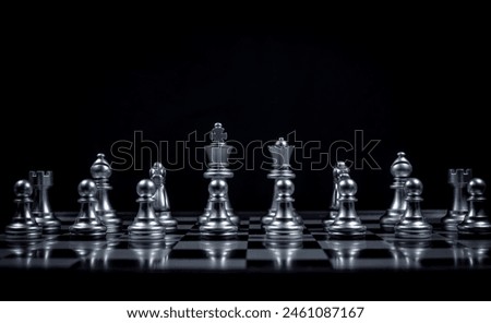 Chess board game in silver team show strategy game as business Challange competitive game ,chessboard this is business strategy plan concept with black background.