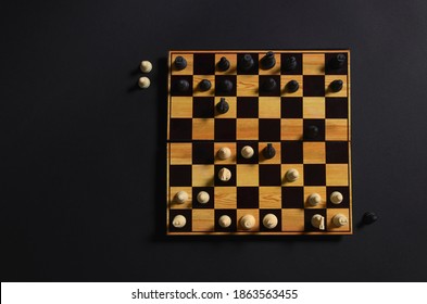 Chess Board With A Game Started. White Started With A Queen's Gambit And Black Captured Two Pawns. Aerial View.