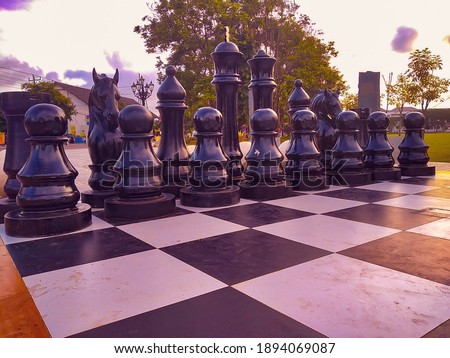 chess board and giant chess pieces