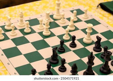 Chess board and pieces in a chess game on a picnic table. - Powered by Shutterstock