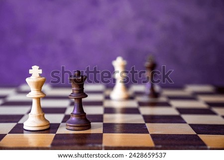 Chess board with chess pieces in wood, sharp and unsharp, couples dark and light