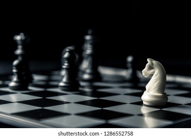 Chess board. White horse threatens black opponent's chess. Horizontal frame