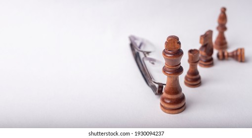 Chess figures with eyeglasse on white background. Banner with copy space - Shutterstock ID 1930094237