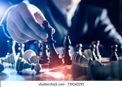 Chess financial business strategy concept. Team leader holding chess piece.