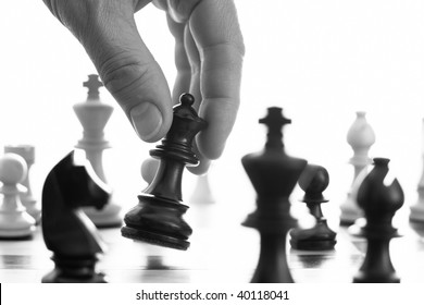 Chess Game Black Queen Advances B&w Close Up Of Hand