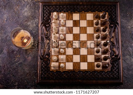 Chess game with figures on a wooden brown field, the concept of a tournament, a sport with a copy space and a selective focus