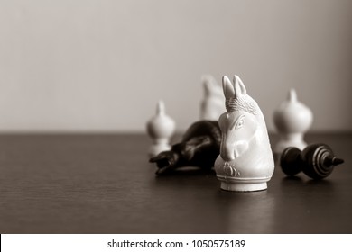 chess game on wood table with soft-focus and over light in the background - Shutterstock ID 1050575189