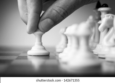 Chess Game, Chess Player Makes A Move The Black Pawn Forward