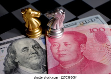 Chess game, two knights face to face on Chinese yuan and US dollar background. Trade way concept. Conflict between two big countries, USA and China concept. Copy space for text.