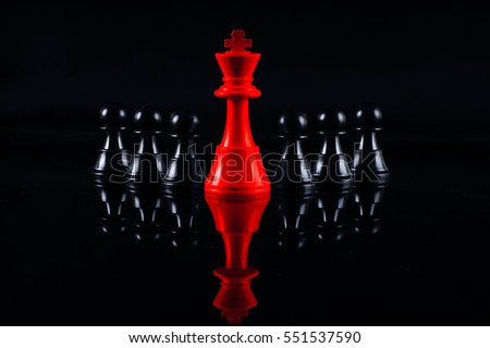 Chess leadership concept with red and black chess isolated in black background
