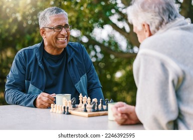 Chess, nature and retirement with senior friends playing a boardgame while bonding outdoor during summer. Park, strategy and game with a mature man and friend thinking about the mental challenge - Powered by Shutterstock