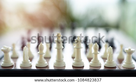 Chess on a Board of wood. bokeh nature background.  game, strategy, management or leadership concept