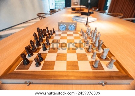 Chess opening on a chess board with chess pieces and a chess clock
