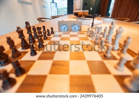 Chess opening on a chess board with chess pieces and a chess clock