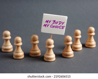 Chess Pawn Protesters Holding A Sign Banner With The Message MY BODY MY CHOICE. Political Activism, Feminism And Women Rights Concept.