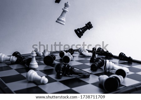 chess pieces fall in disarray on the chessboard. The concept of losing a game of chess