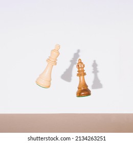 Chess Pieces, King And Queen Falling Down. Chess, Competition Or Education Concept.