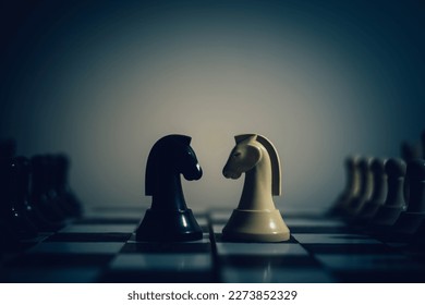 Chess pieces knights facing each other for a standoff on a chessboard, the concept of two leaders who oppose each other, Chess knights head to head.