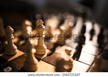 Chess pieces on the chessboard. Game of Chess. Close Up Playing Chess Game. Strategy game requiring concentration and wit. Symbol for good business acumen and tactics.
