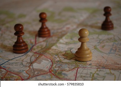 Chess Pieces On Map Depicting Strategic Planning