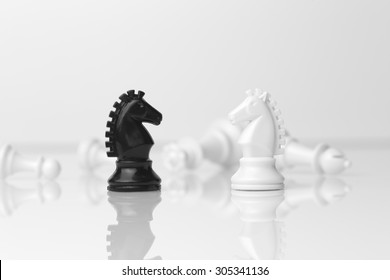 Chess pieces, two knights facing each other - business and strategy concept