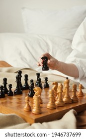 Chess Player Woman Learns Chess Opening By Playing With Himself. Black Horse One Step Forward. Chess Wooden Board With Chess Pieces On Light Background. Strategy Board Game Played. Closeup