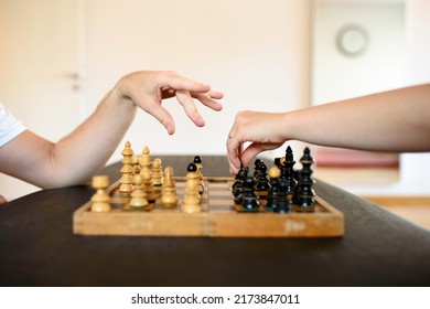 Chess table and two hands preparing for the move. A game of outwitting.
Wisdom, right move, intelligence, cognitive therapy, out thinking, competition concepts.
