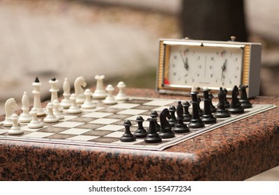 Chessboard With Chess And Timer In The Park