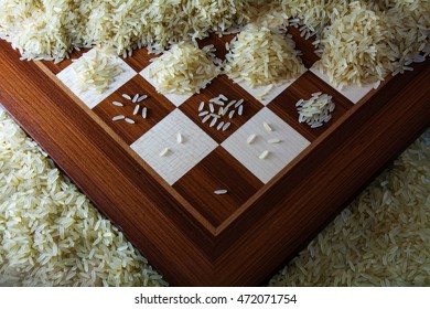 chessboard with growing heaps of rice grains, view from above showing the exponential function and unlimited growth, selected focus