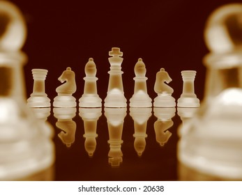 Chessmen in a row in bright sepia.
