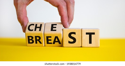 Chest or breast symbol. Businessman turns wooden cubes and changes the word 'breast' to 'chest'. Beautiful yellow table, white background. Social and chest or breast concept. Copy space. - Shutterstock ID 1938014779