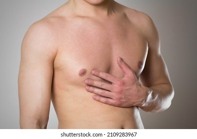 Chest pain. The man's chest hurts. - Shutterstock ID 2109283967