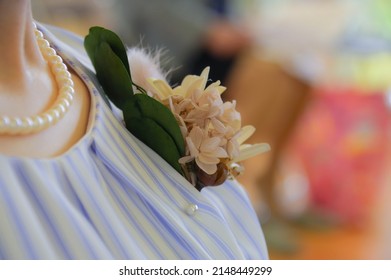 The chest of a woman wearing a corsage