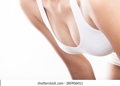 The chest of a young sexy asian woman in white bra isolated on white background