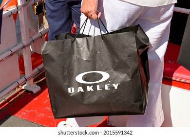 Chester, Cheshire, England - July 2021: Person with a carrier bag of goods purchased from Oakley