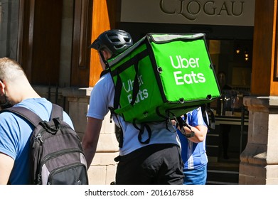 Chester, Cheshire, England - July 2021: Cycilst With An Insulated Container On His Back Delivering Take Away Food For Uber Eats