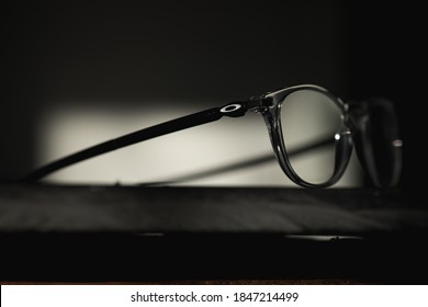 Chester, UK / November, 2020 / Close up shot of a pair of "Oakley Pinchman R" glasses. Sitting on a slate table in a office/home environment. Nice lighting from the window creating abstract shadows.