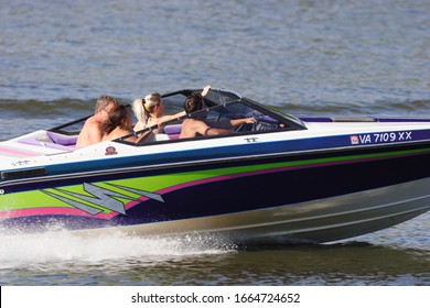 Chester, Virginia/USA - July 5,2010:People boating on the James river near the Dutch Gap coal-fired power plant.