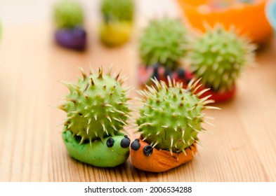 Chestnut Fruit Hedgehog Family. Toy Animal Made From Play-dough And Real Chestnut. Contest Of Autumn Harvest Festival In Kindergarten.  