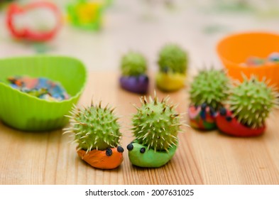 Chestnut Fruit Hedgehog Family. Toy Animal Made From Play-dough And Real Chestnut. Contest Of Autumn Harvest Festival In Kindergarten.  