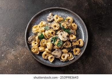 Chestnut Mushrooms and spinach tortellini served with parmesan cheese. - Powered by Shutterstock