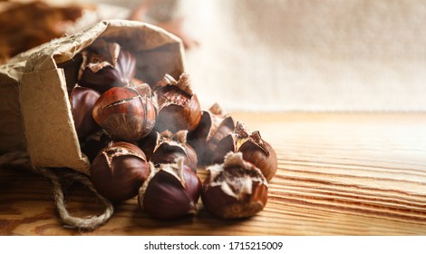 Chestnuts on a wooden background.