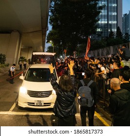 Cheung Sha Wan, Hong Kong- 02-12-20: Supporters of Joshua, Agnes, and Ivan surrounding the prison van, omitting policies warning. They were sentenced to imprisonment on today's trial.