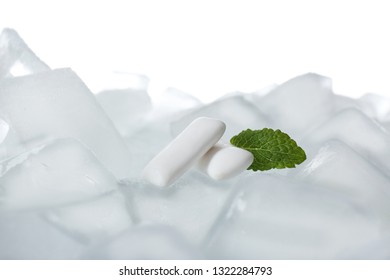 Chewing Gums And Mint On Ice Cubes Against White Background, Closeup